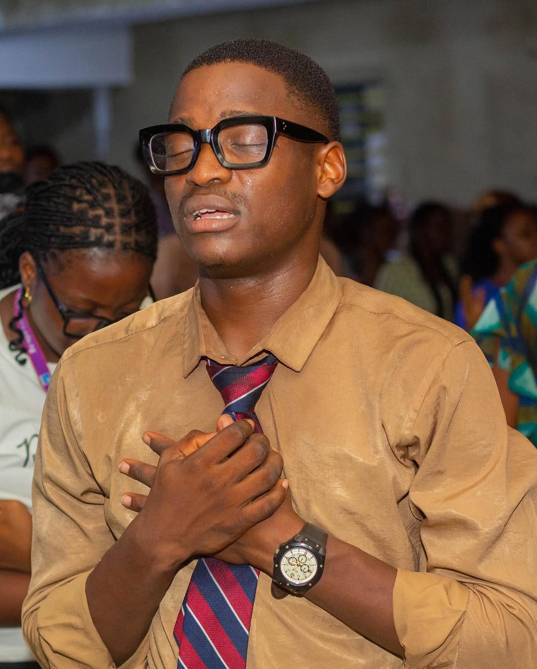 A boy worshipping during service